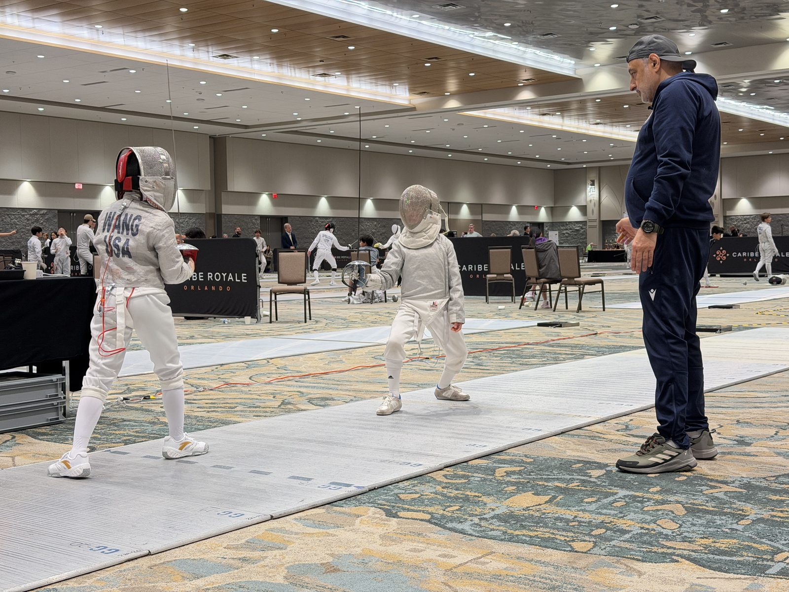 Coach Boris coaching young fencer at national tournament