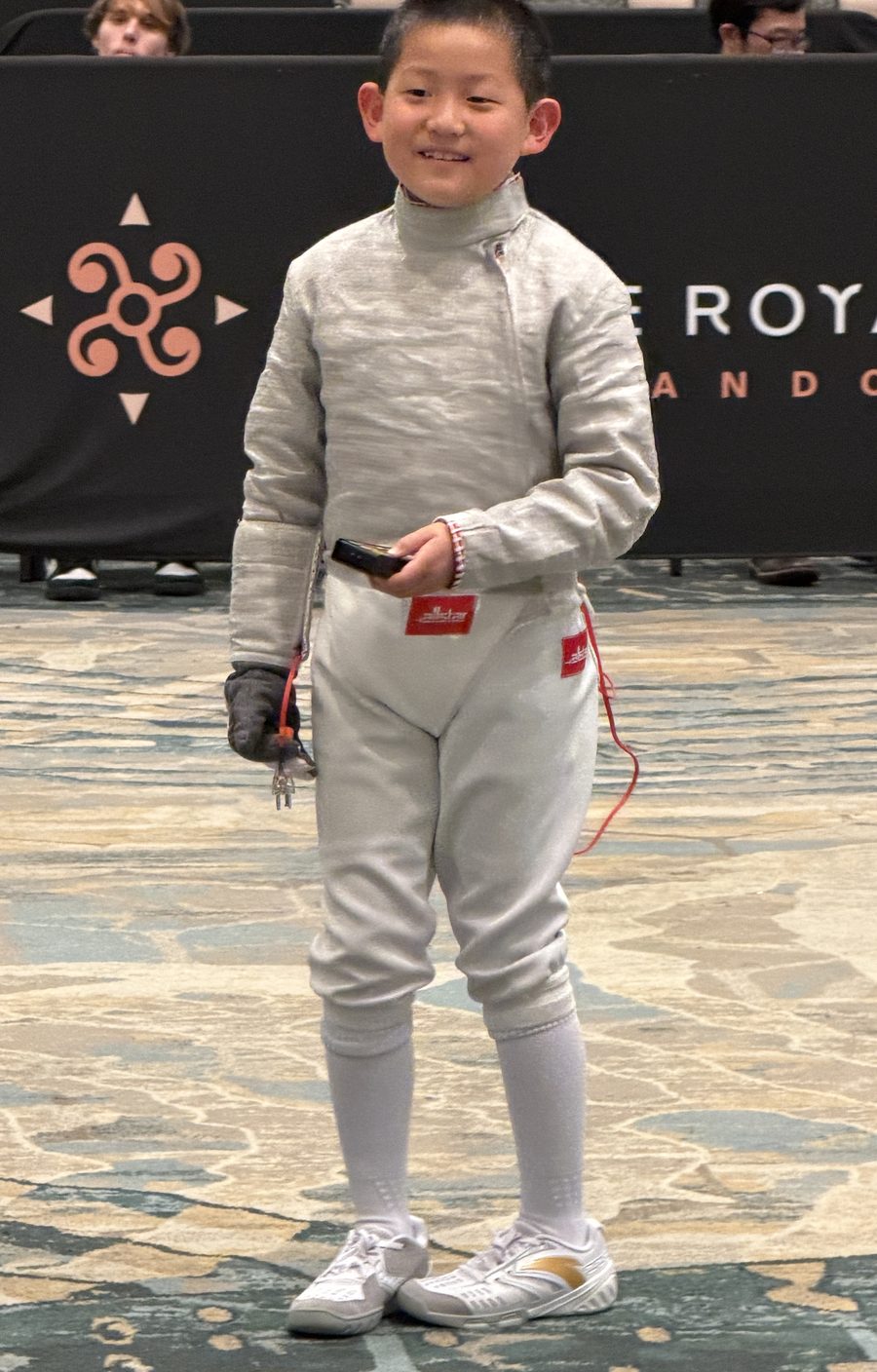 Young CSFA fencer ready to compete in fencing uniform