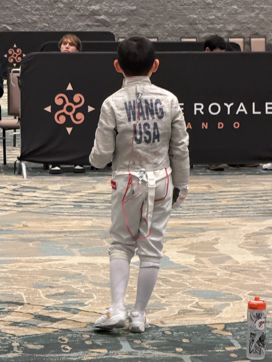Young CSFA fencer in USA uniform at competition — the goal your child can reach