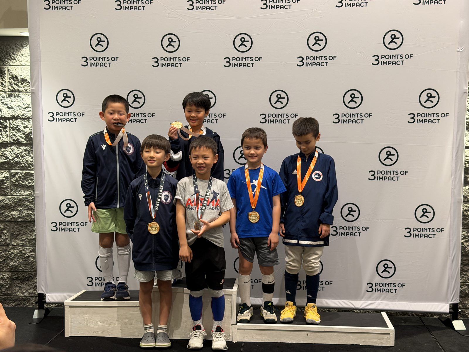 Young CSFA fencers on medal podium at tournament