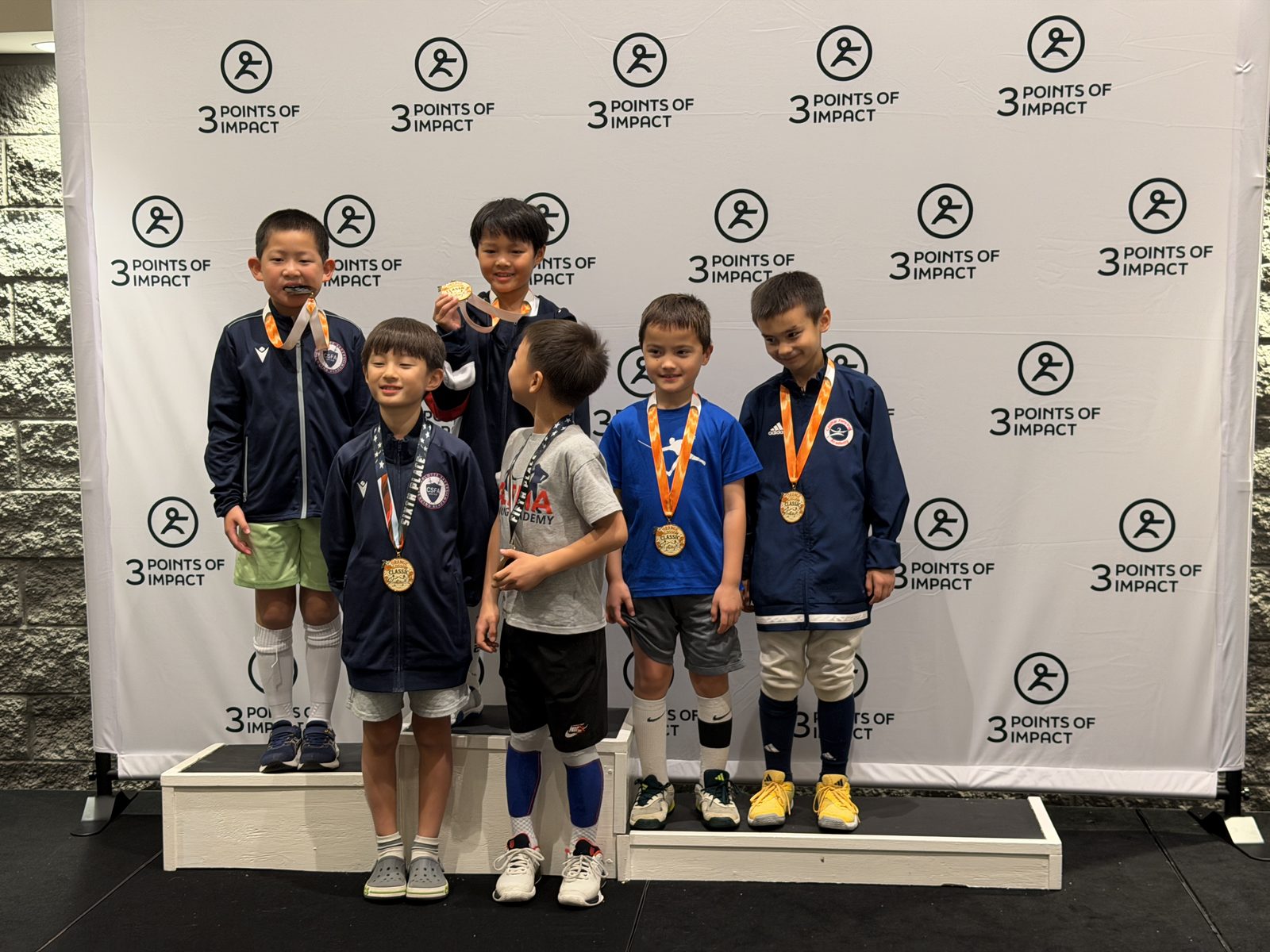 CSFA youth fencers celebrating competition results with medals