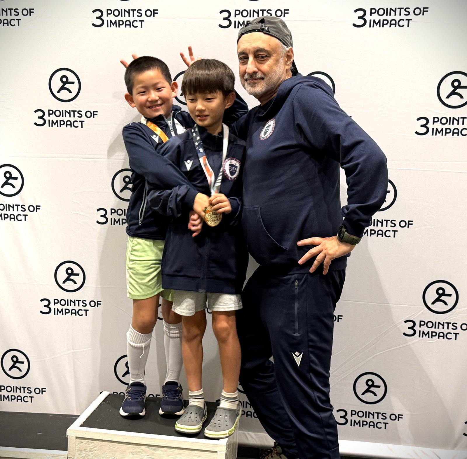 Coach Boris with young CSFA medal winners celebrating at tournament